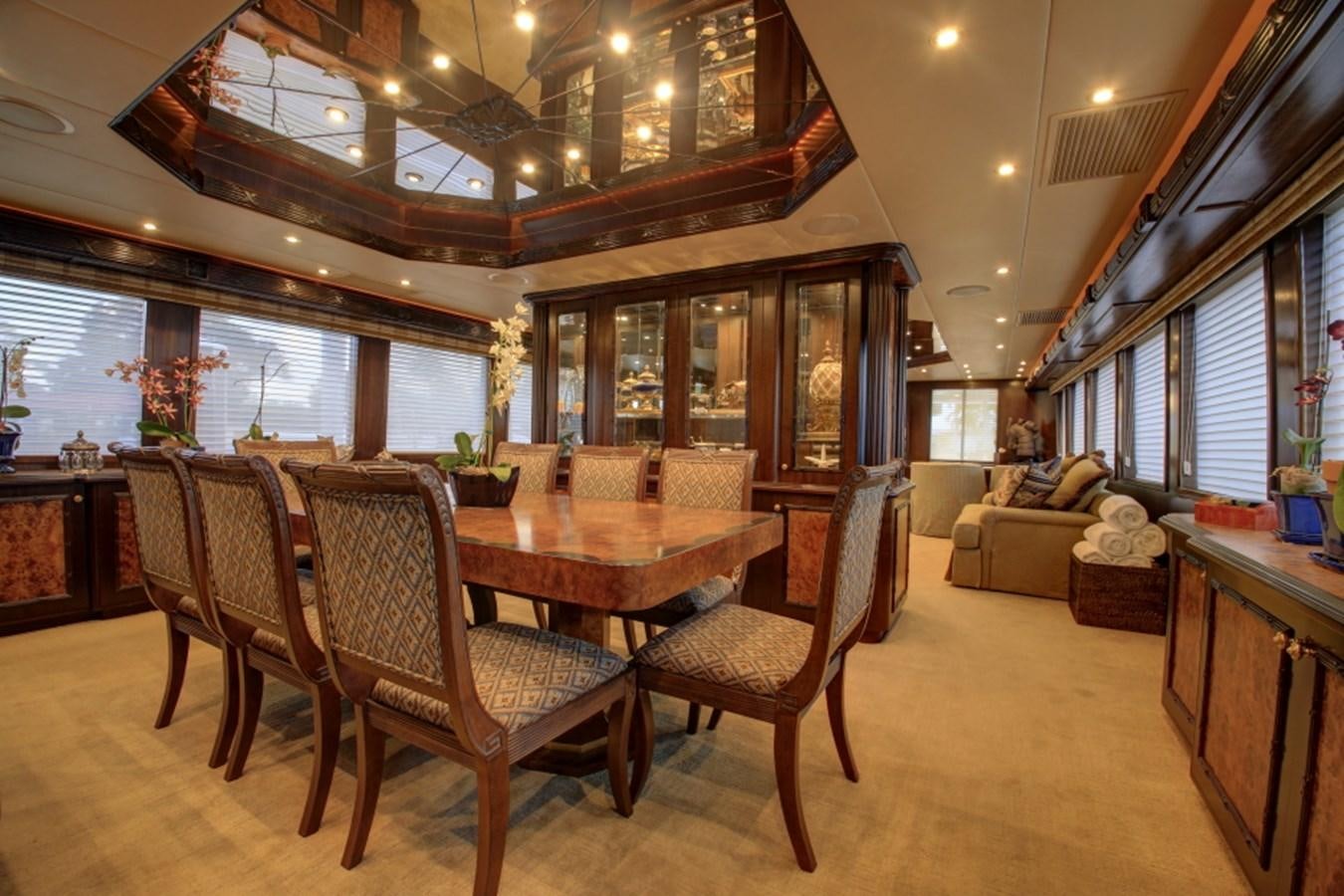 a large dining room with a wood table and chairs aboard SUNDAY MONEY Yacht for Sale