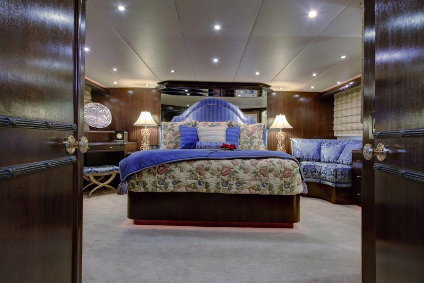a bedroom with a bed and a door aboard SUNDAY MONEY Yacht for Sale