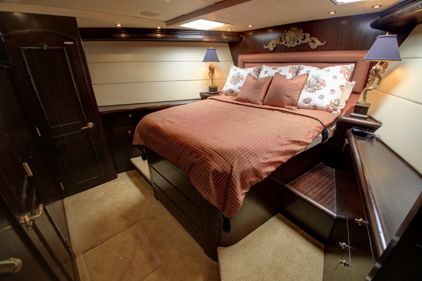 a bedroom with a double bed aboard SUNDAY MONEY Yacht for Sale