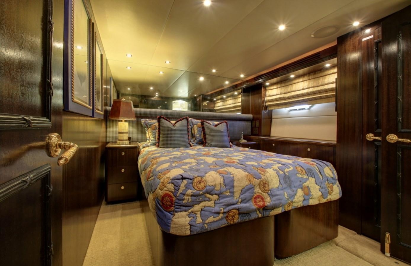 a bedroom with a bed and a wood door aboard SUNDAY MONEY Yacht for Sale