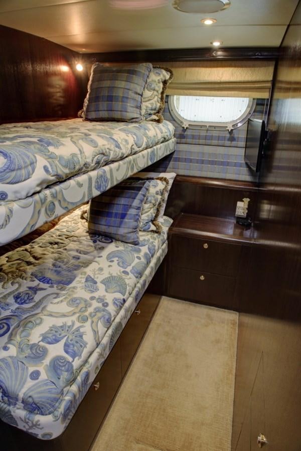 a bedroom with a bed and a window aboard SUNDAY MONEY Yacht for Sale