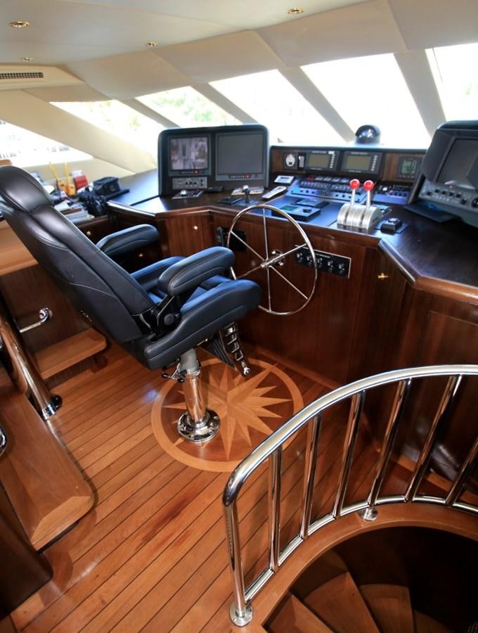 a leather chair in a room with computers and monitors aboard SUNDAY MONEY Yacht for Sale