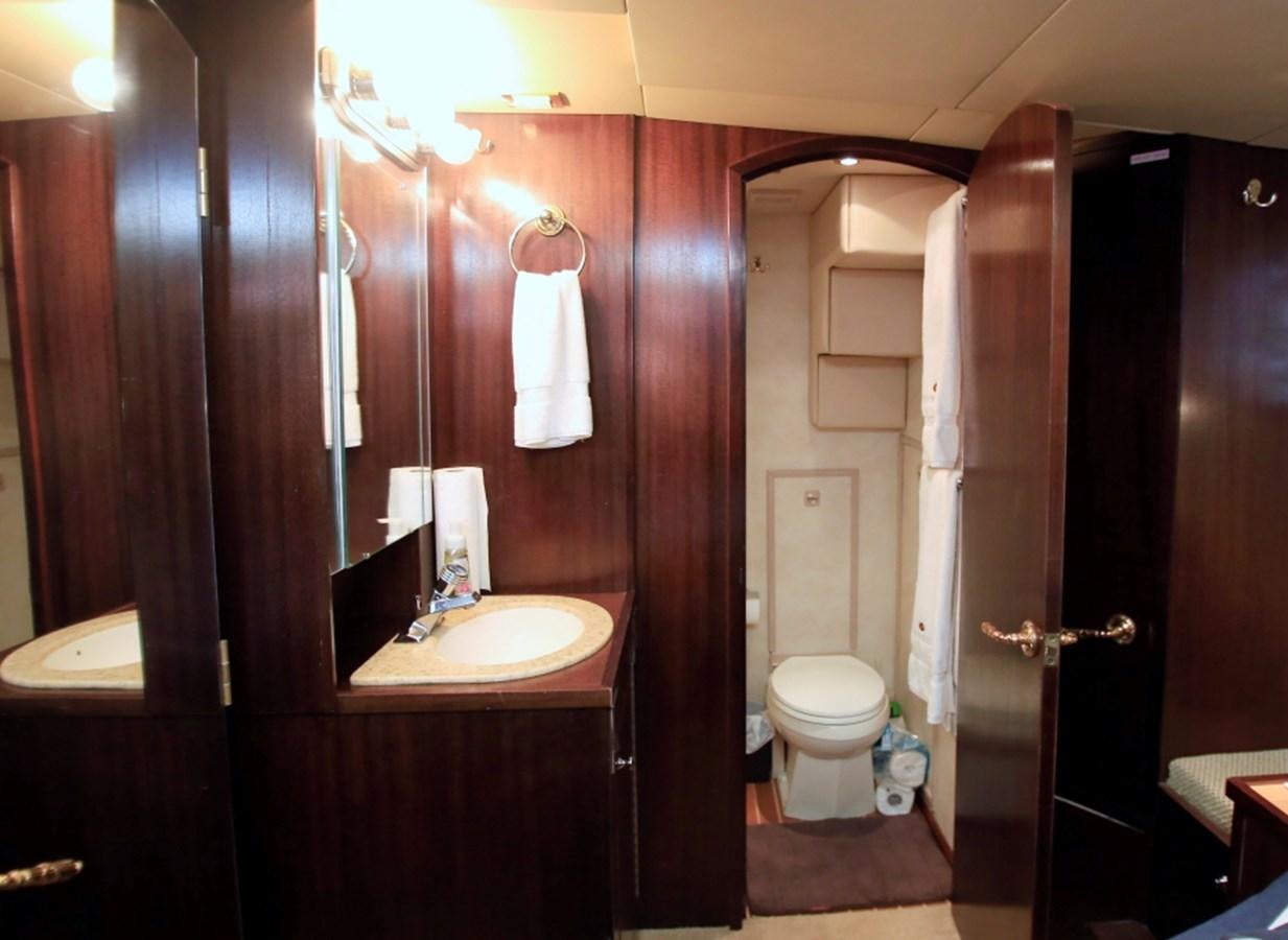 a bathroom with a sink toilet and a mirror aboard SUNDAY MONEY Yacht for Sale