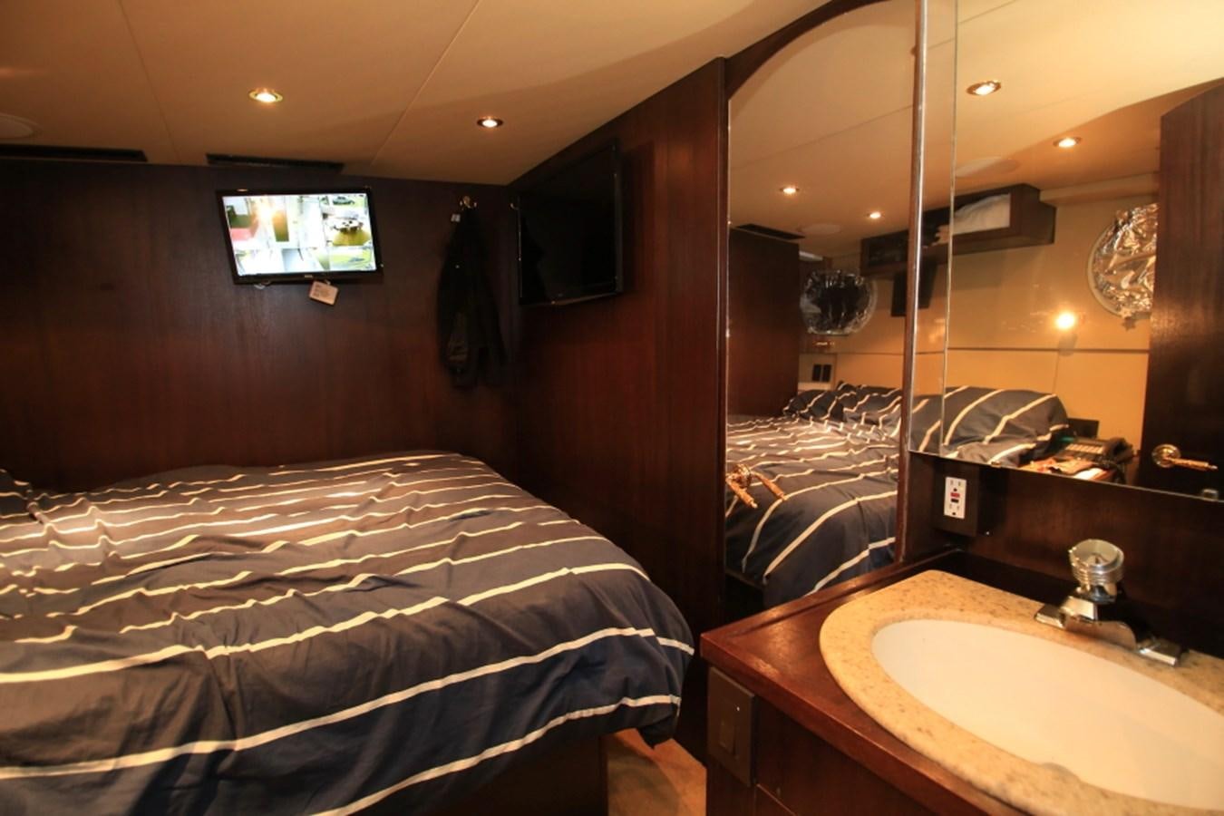 a hotel room with a bed and a television aboard SUNDAY MONEY Yacht for Sale