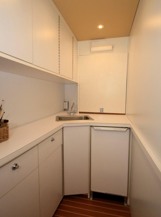 a kitchen with white cabinets aboard SUNDAY MONEY Yacht for Sale