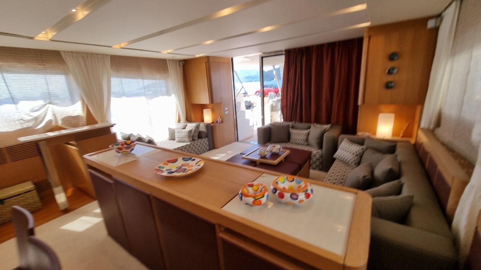 a living room with a couch and a table aboard RED ROSE Yacht for Sale