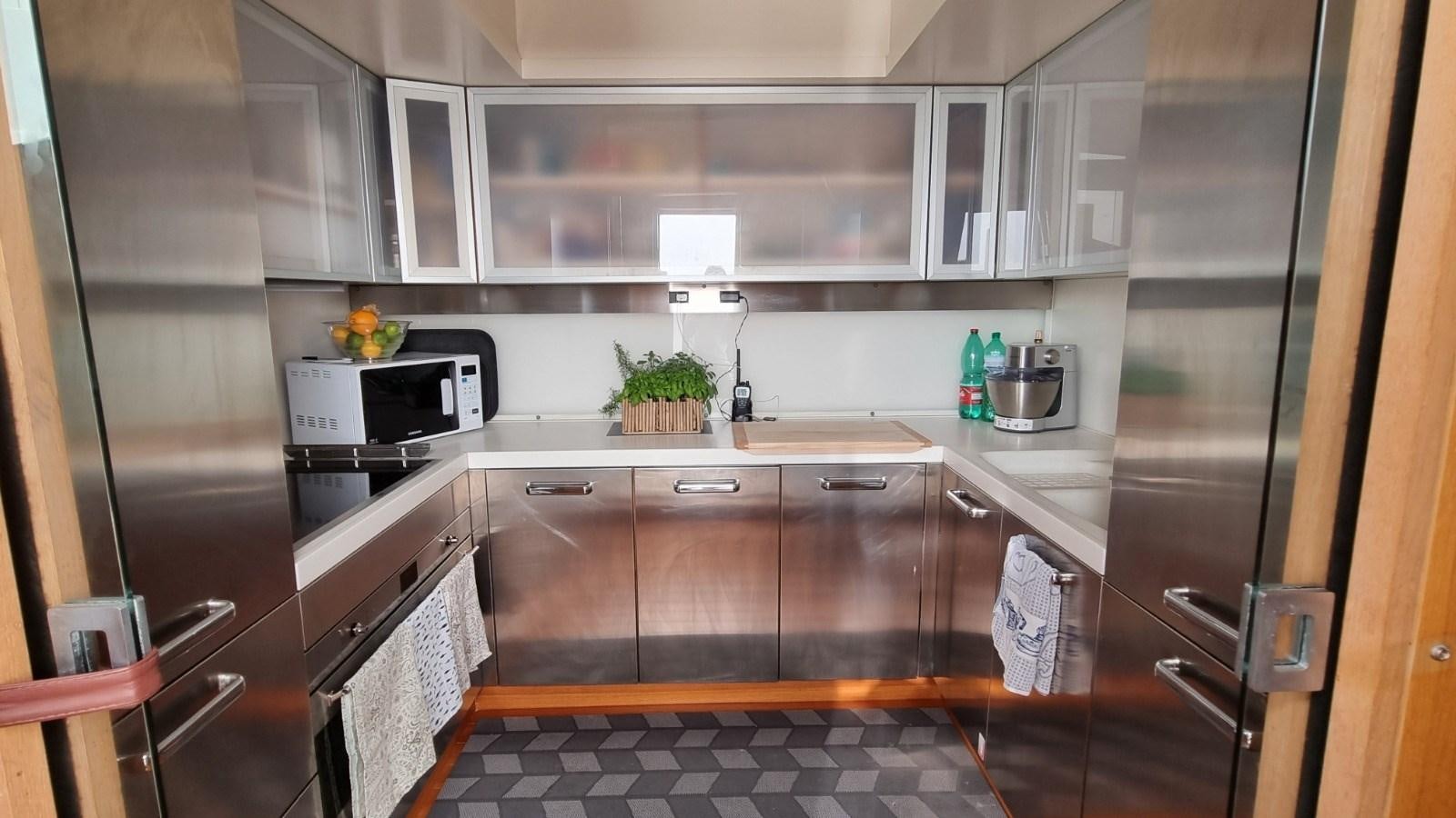 a kitchen with black cabinets aboard RED ROSE Yacht for Sale