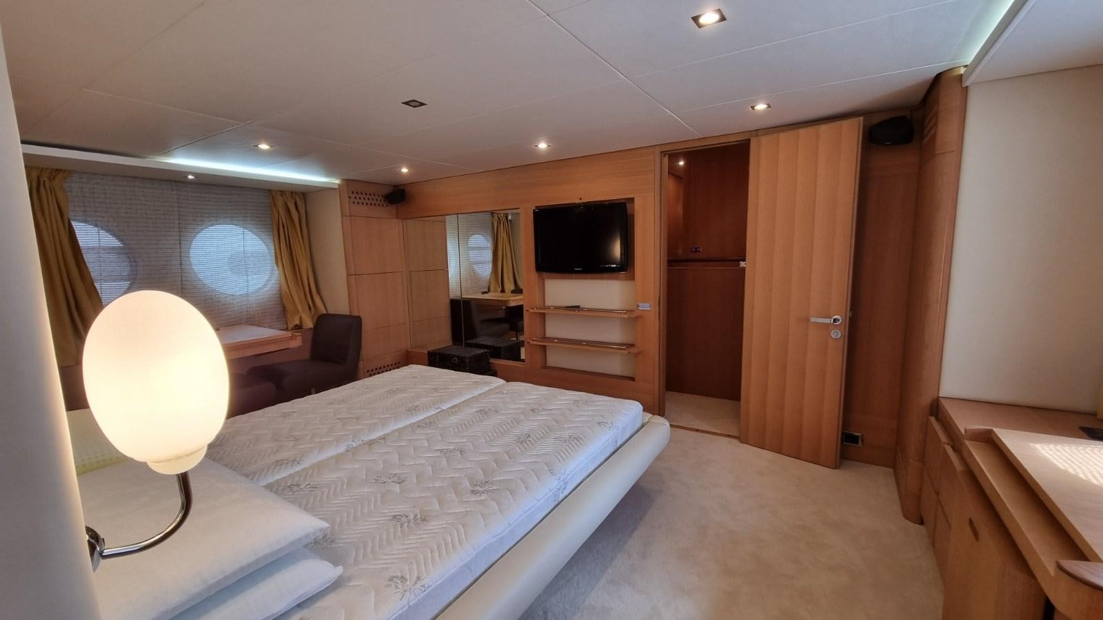 a hotel room with a bed and tv aboard RED ROSE Yacht for Sale