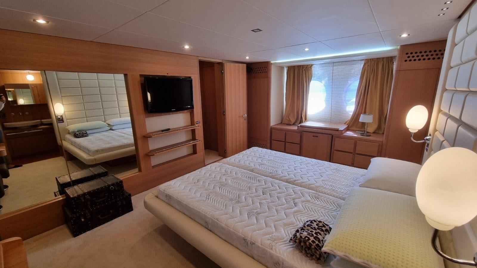 a hotel room with a bed and tv aboard RED ROSE Yacht for Sale