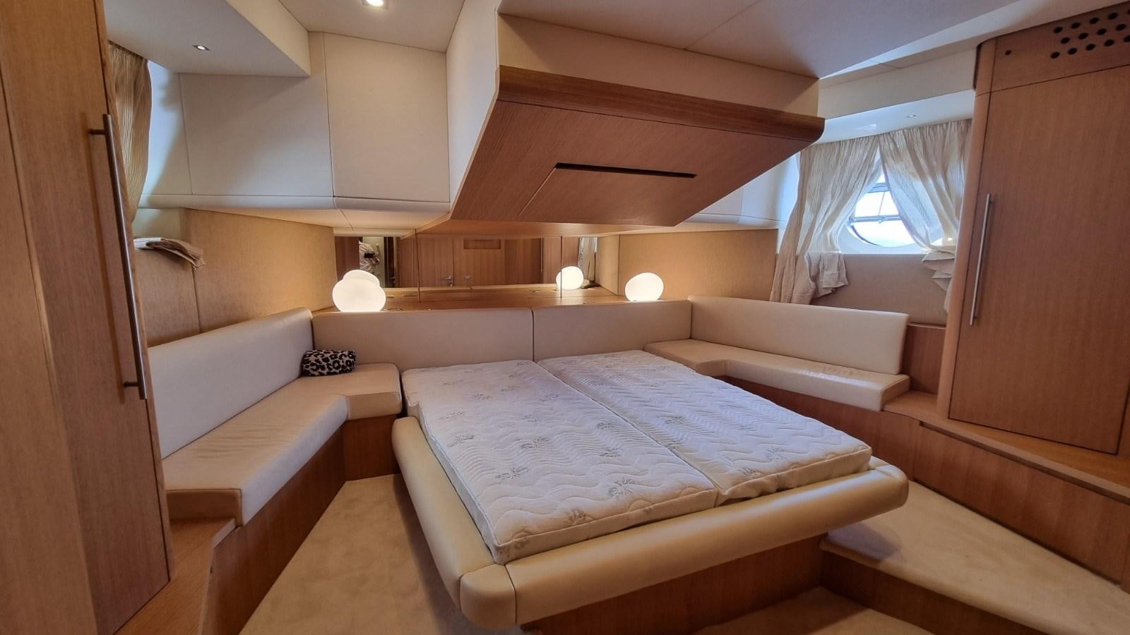 a room with a bed and a window aboard RED ROSE Yacht for Sale