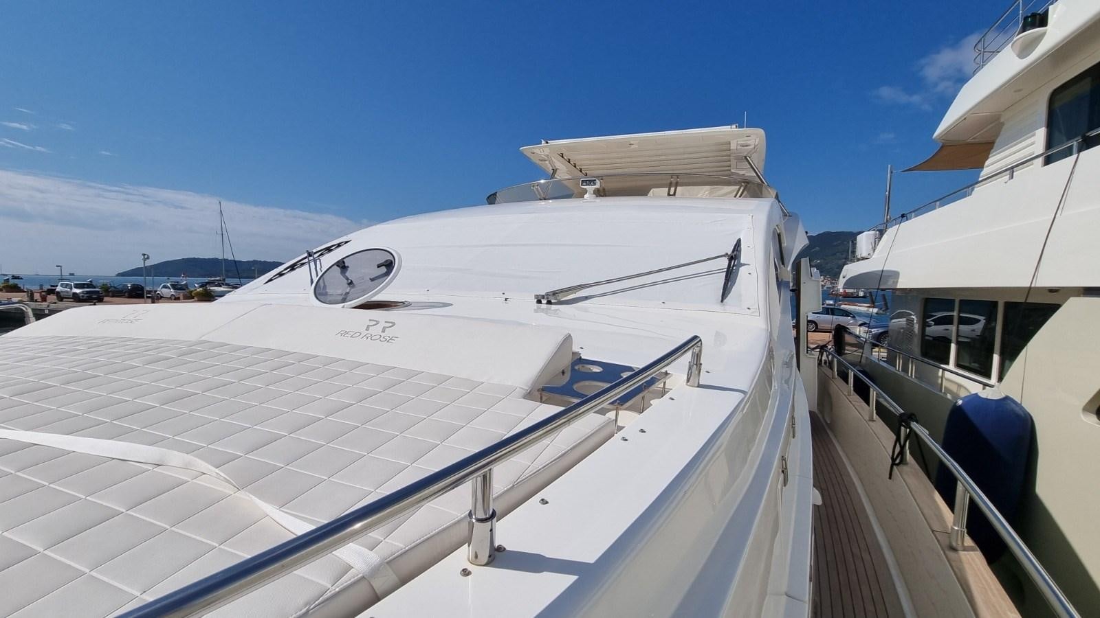 a boat docked at a pier aboard RED ROSE Yacht for Sale