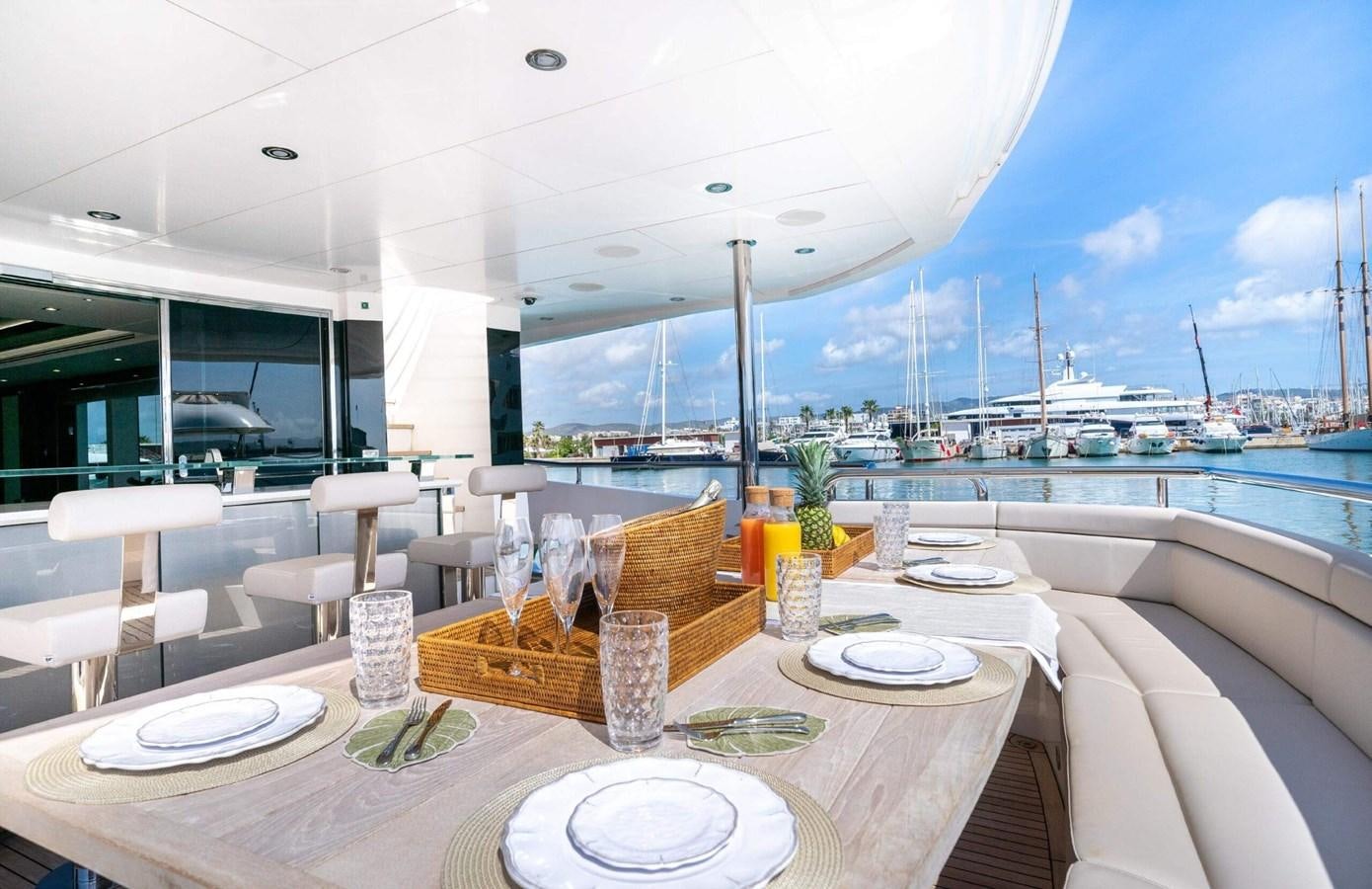 a table with plates and glasses on it aboard HKMAS Yacht for Sale