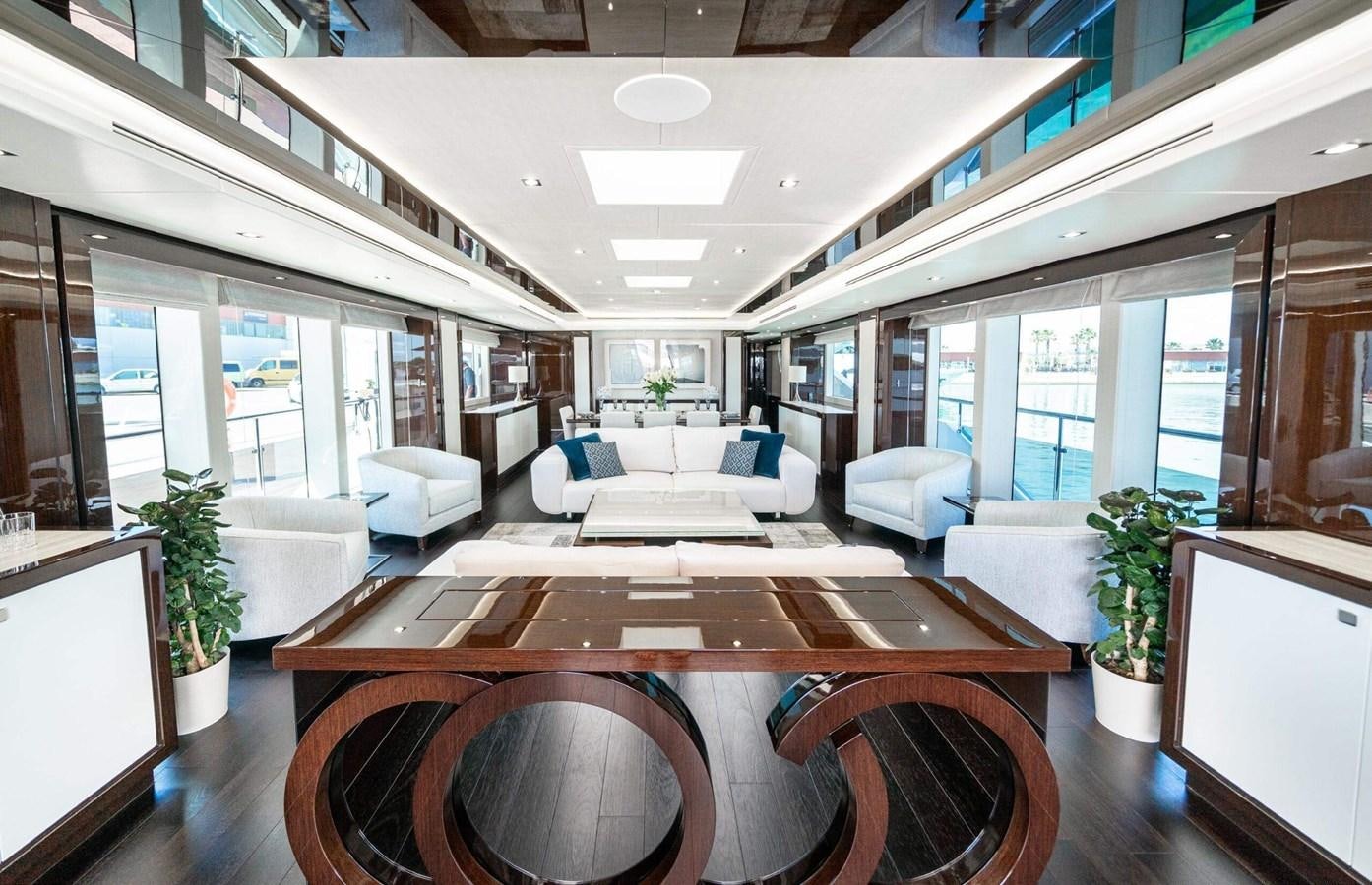 a large room with a table and chairs aboard HKMAS Yacht for Sale