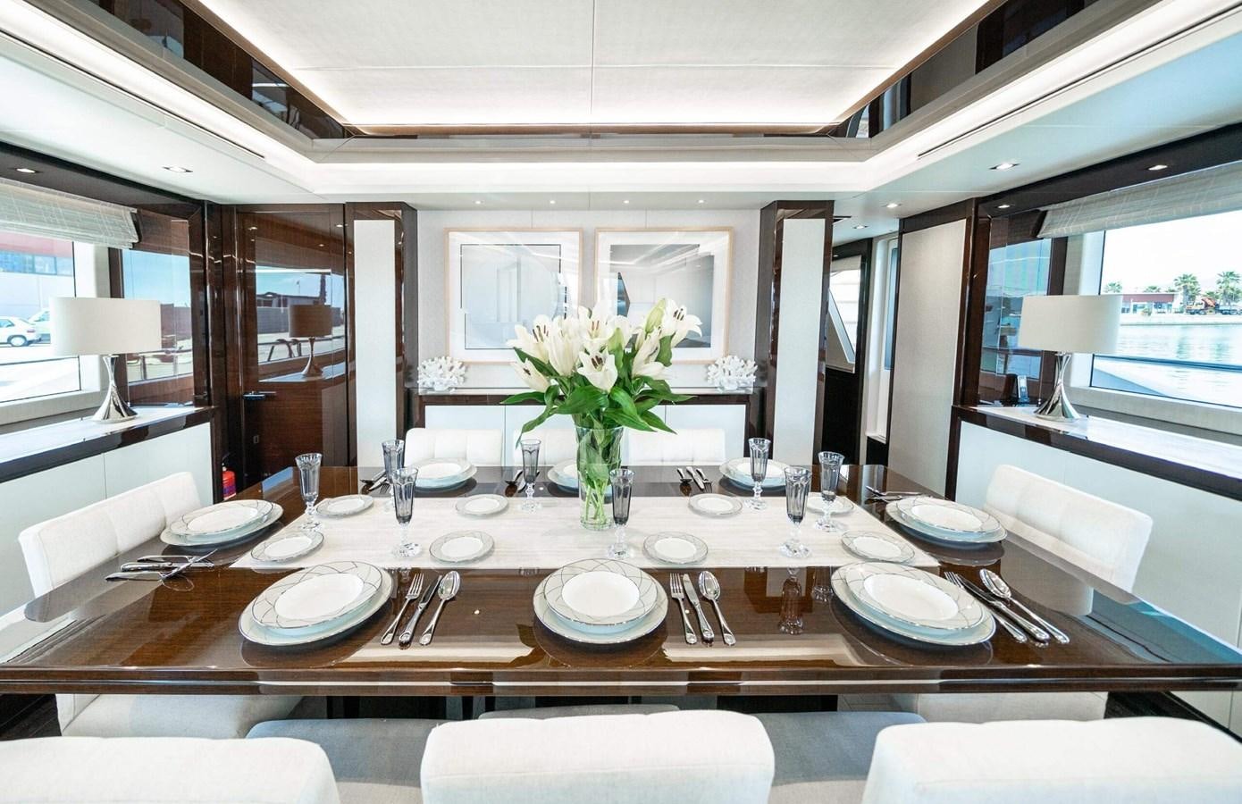 a dining table with plates and silverware aboard HKMAS Yacht for Sale