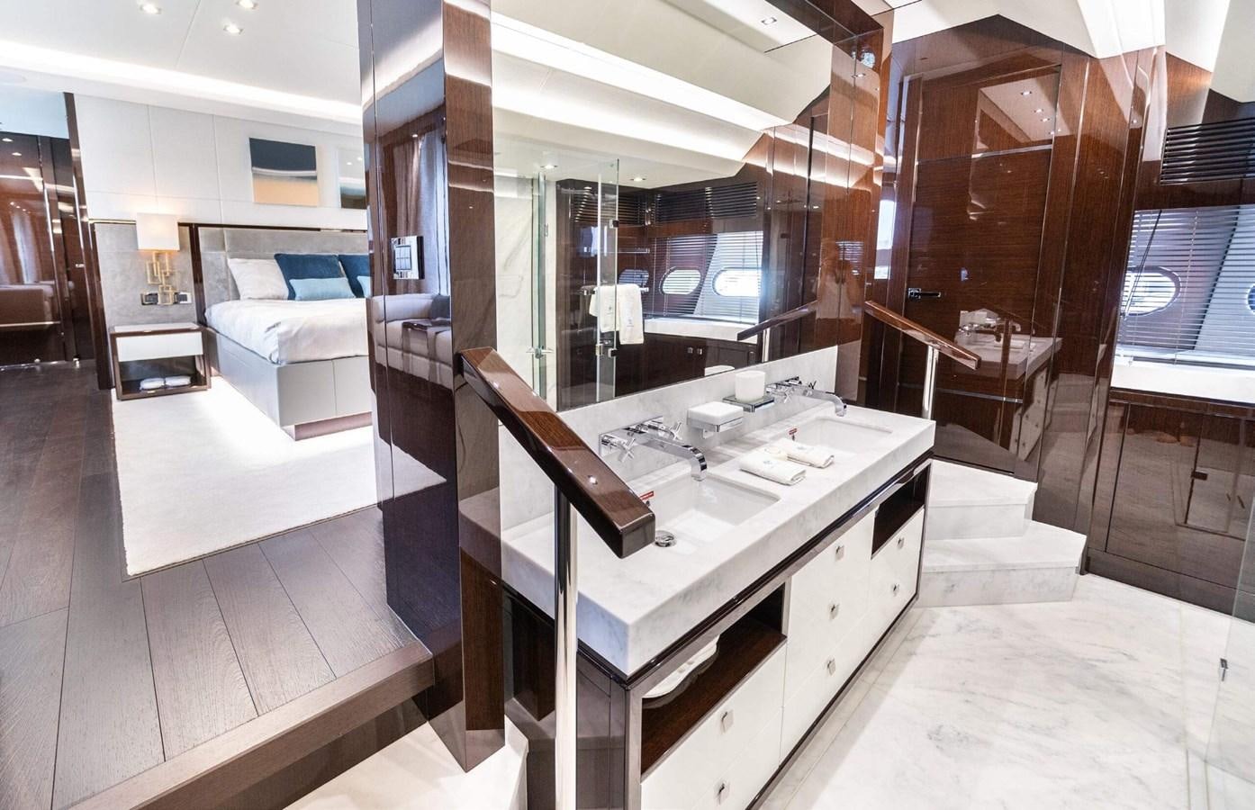 a kitchen with a table and chairs aboard HKMAS Yacht for Sale
