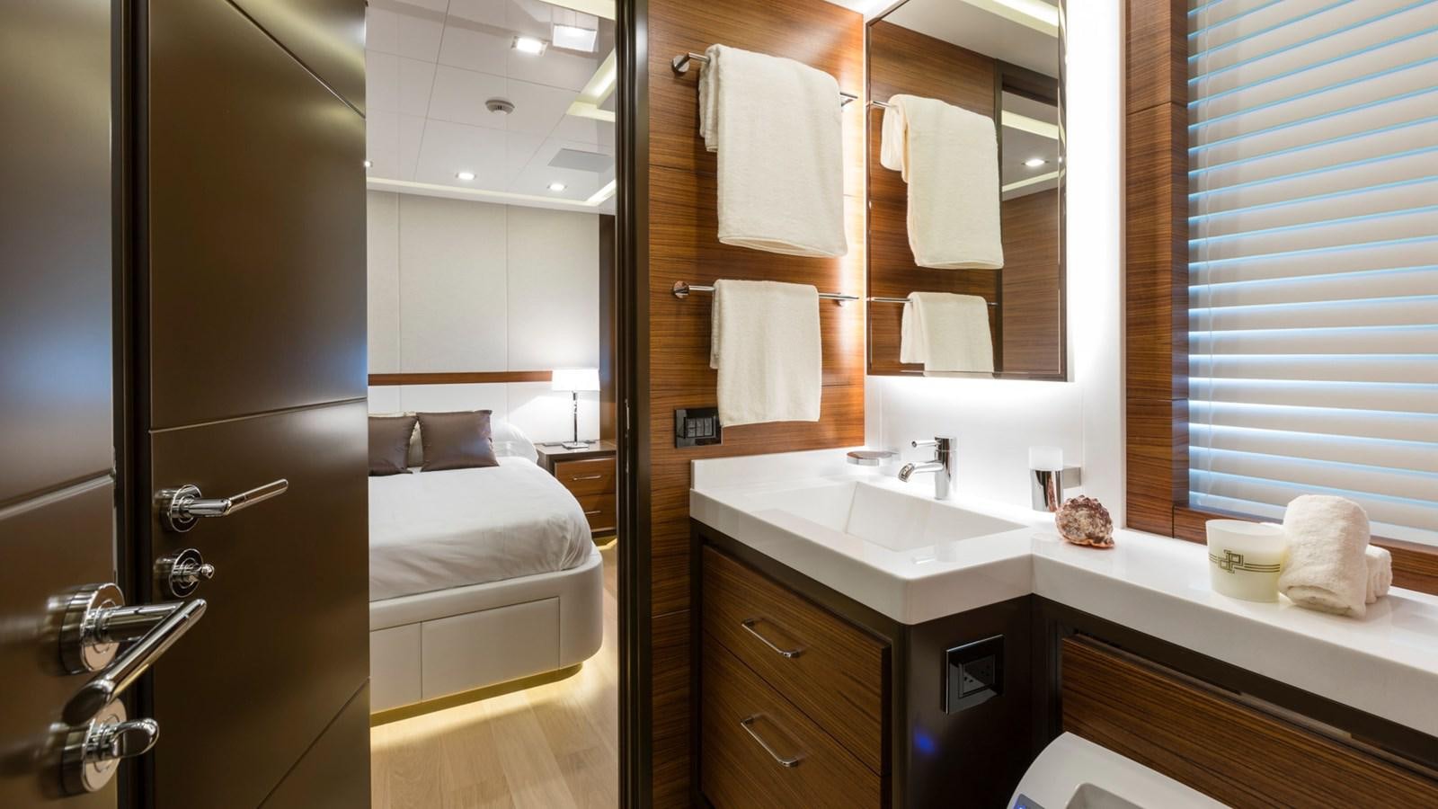 a bathroom with a sink and a mirror aboard FIREFLY Yacht for Sale