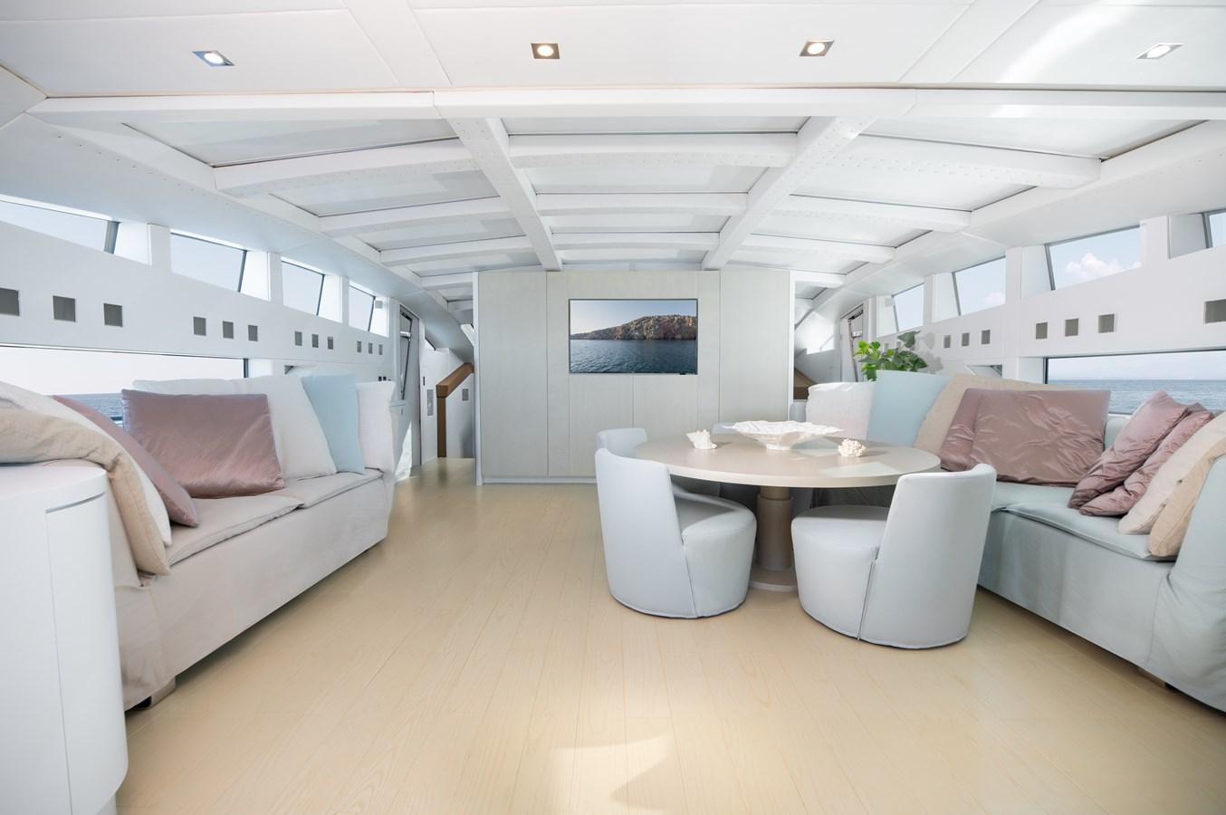 a living room with a couch and a table aboard BLUE PRINCESS STAR Yacht for Sale