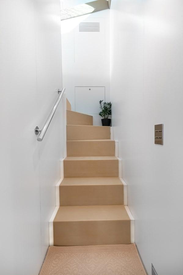 a staircase with a plant on the top aboard BLUE PRINCESS STAR Yacht for Sale