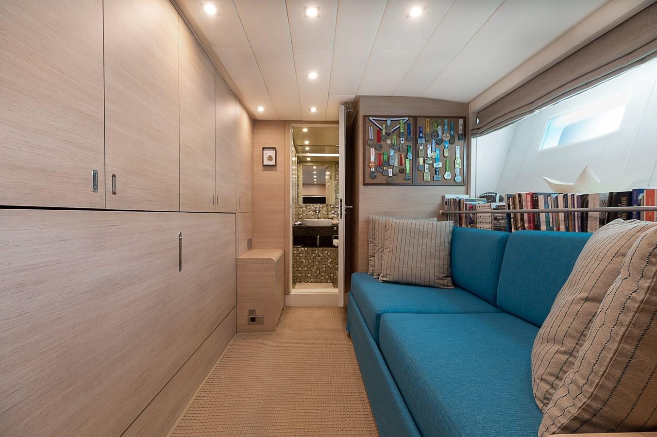 a room with a couch and a bookcase aboard BLUE PRINCESS STAR Yacht for Sale