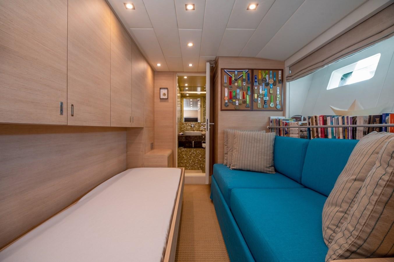 a room with a couch and a bookcase aboard BLUE PRINCESS STAR Yacht for Sale