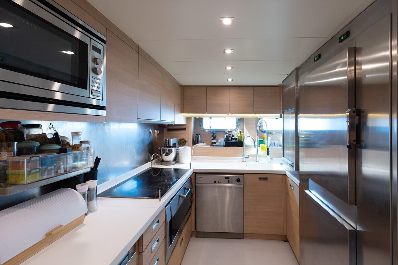 a kitchen with a stainless steel refrigerator aboard BLUE PRINCESS STAR Yacht for Sale