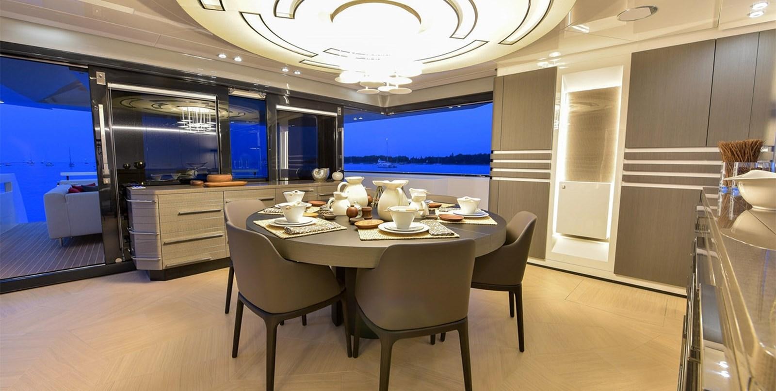 a table with chairs and a couple of plates on it aboard ARIA.S Yacht for Sale