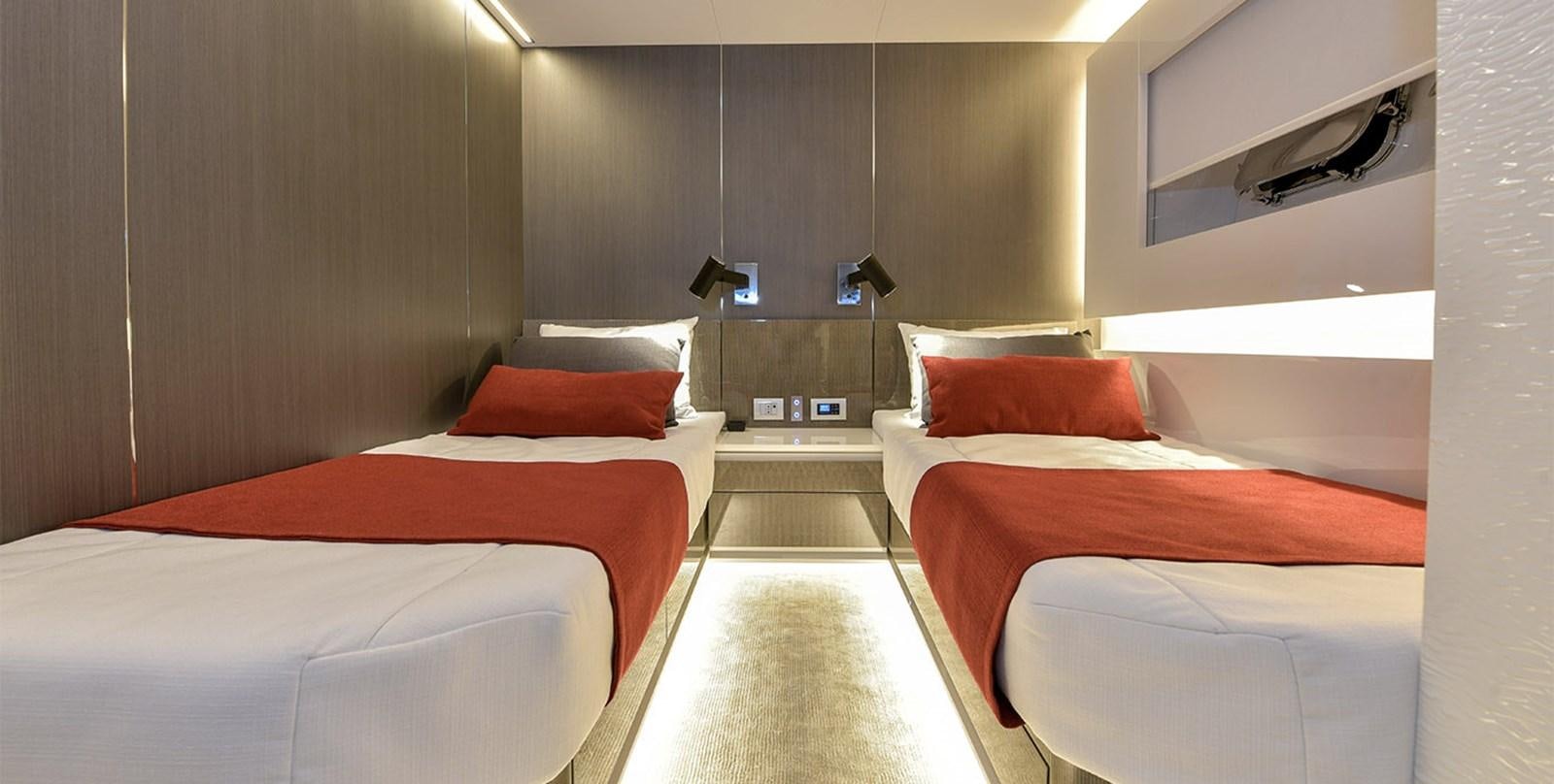 a room with beds and a mirror aboard ARIA.S Yacht for Sale