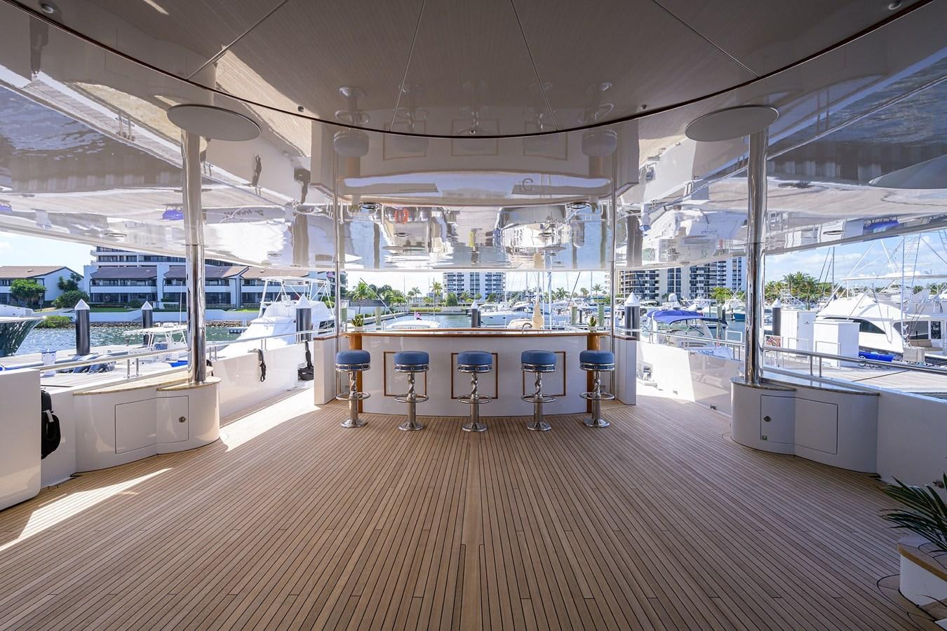 a large room with tables and chairs aboard REVIVE Yacht for Sale