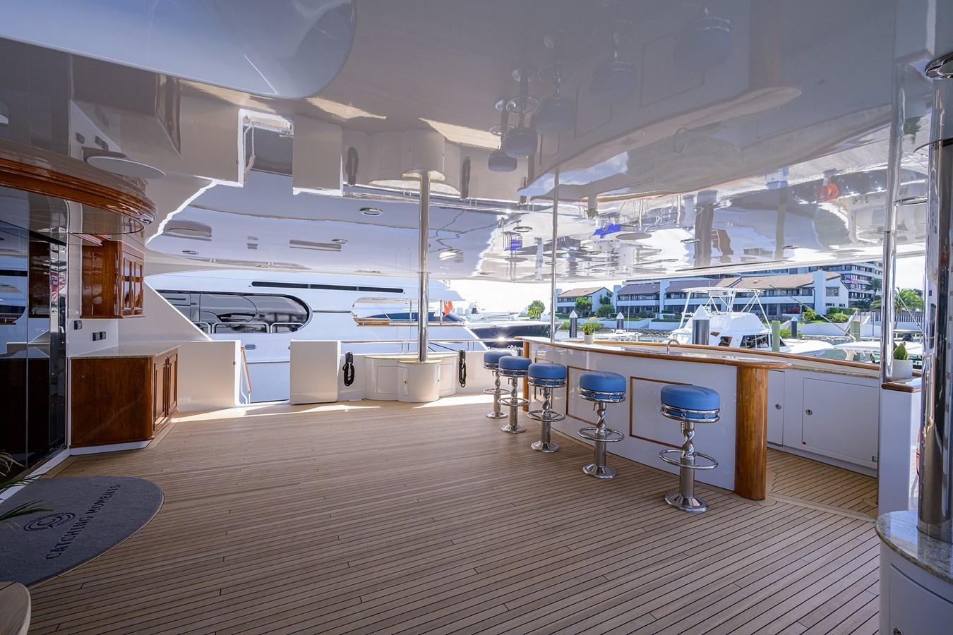 a room with tables and chairs aboard REVIVE Yacht for Sale