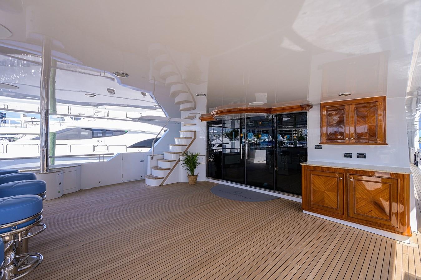 a room with a staircase and a wood floor aboard REVIVE Yacht for Sale
