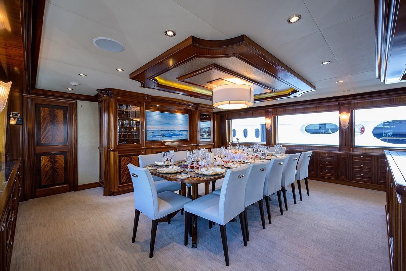 a dining room with a table and chairs aboard REVIVE Yacht for Sale