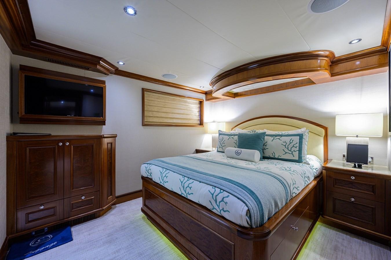 a bedroom with a bed and a television aboard REVIVE Yacht for Sale