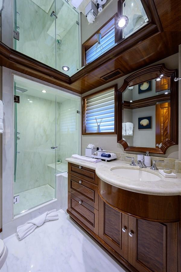 a bathroom with a sink and a mirror aboard REVIVE Yacht for Sale