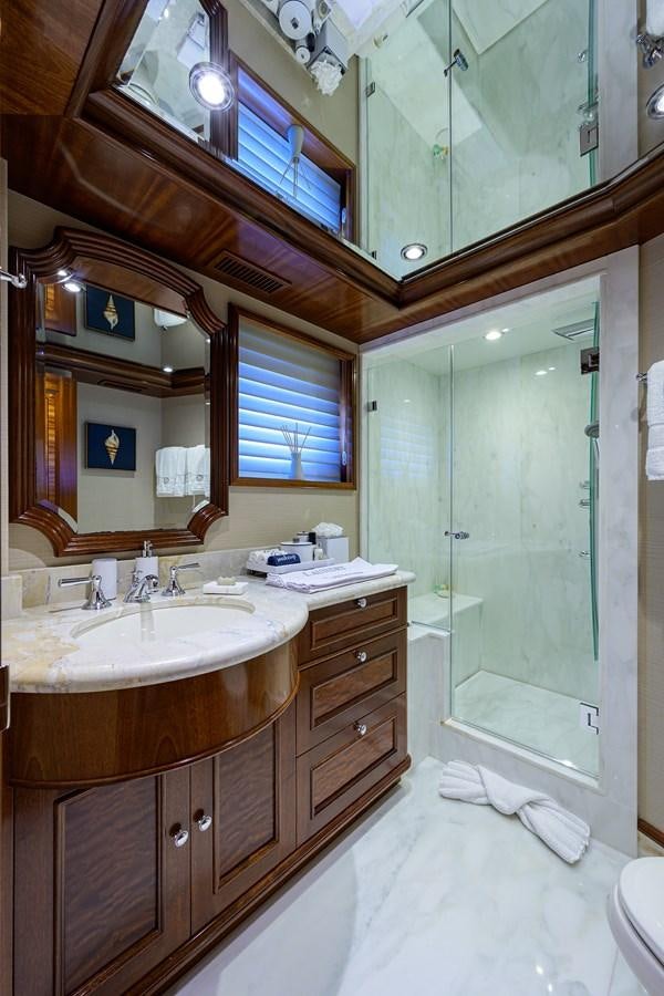 a bathroom with a large mirror aboard REVIVE Yacht for Sale