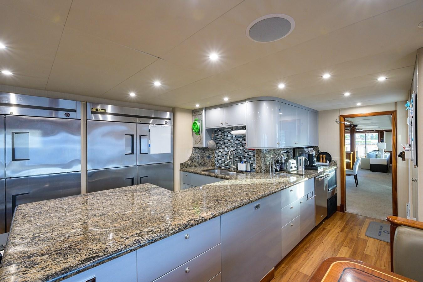 a large kitchen with marble counters aboard REVIVE Yacht for Sale