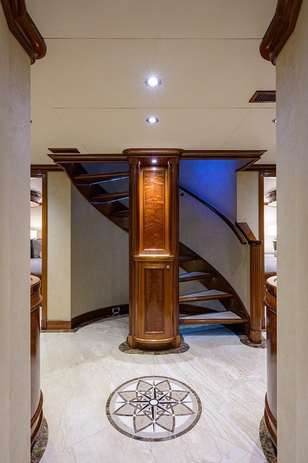 a large wooden fireplace aboard REVIVE Yacht for Sale