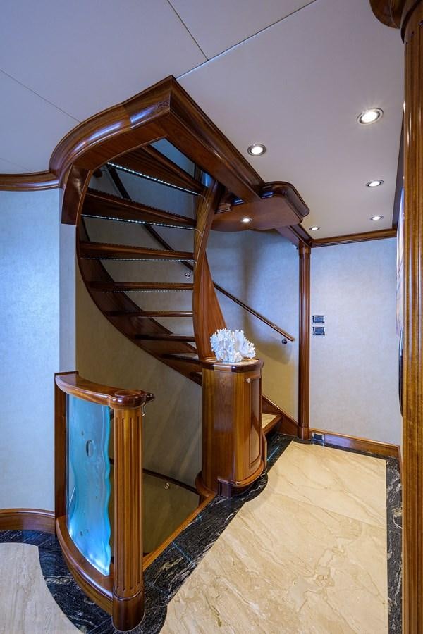a wooden staircase in a house aboard REVIVE Yacht for Sale