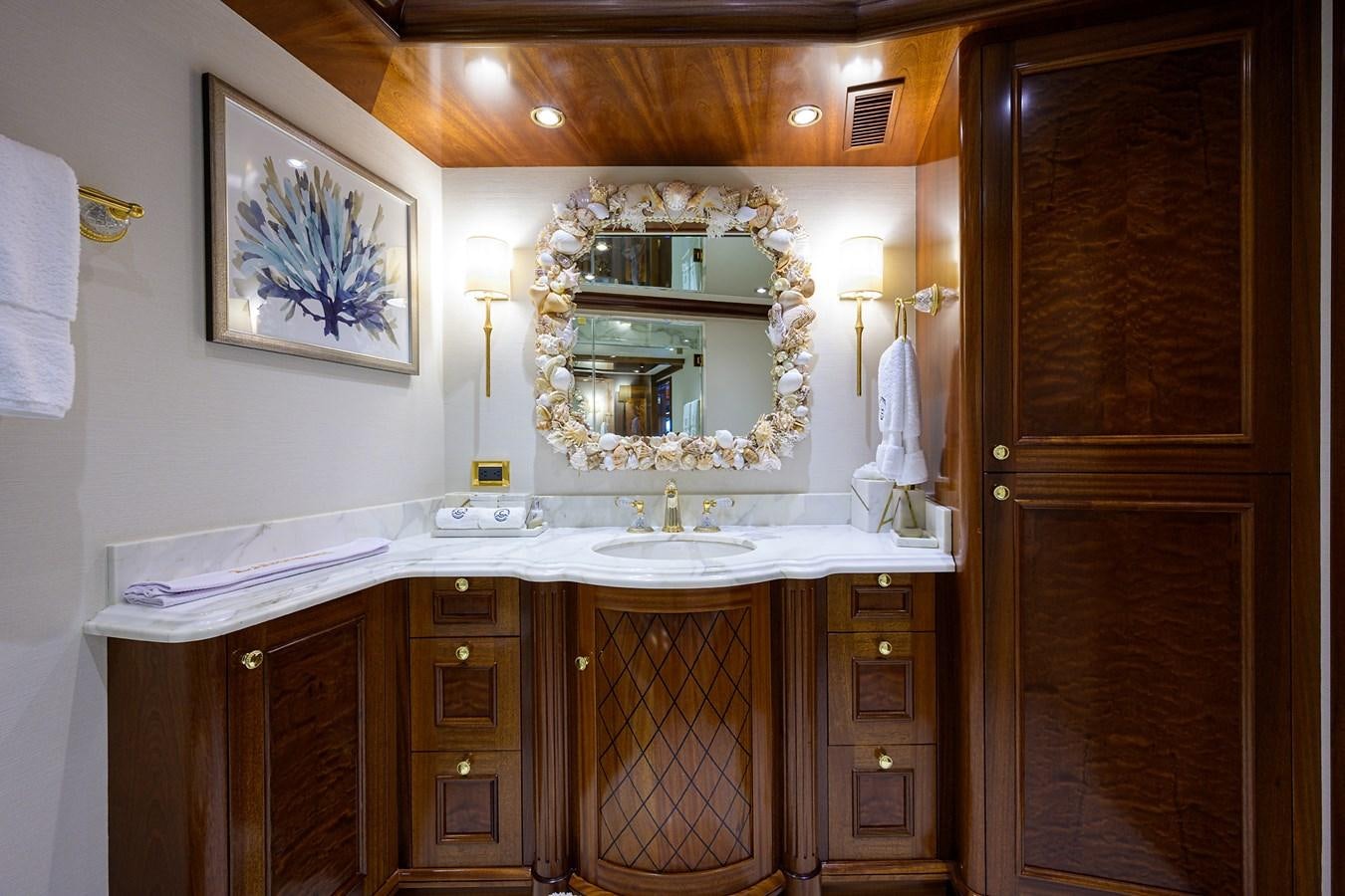 a bathroom with a sink and cabinets aboard REVIVE Yacht for Sale