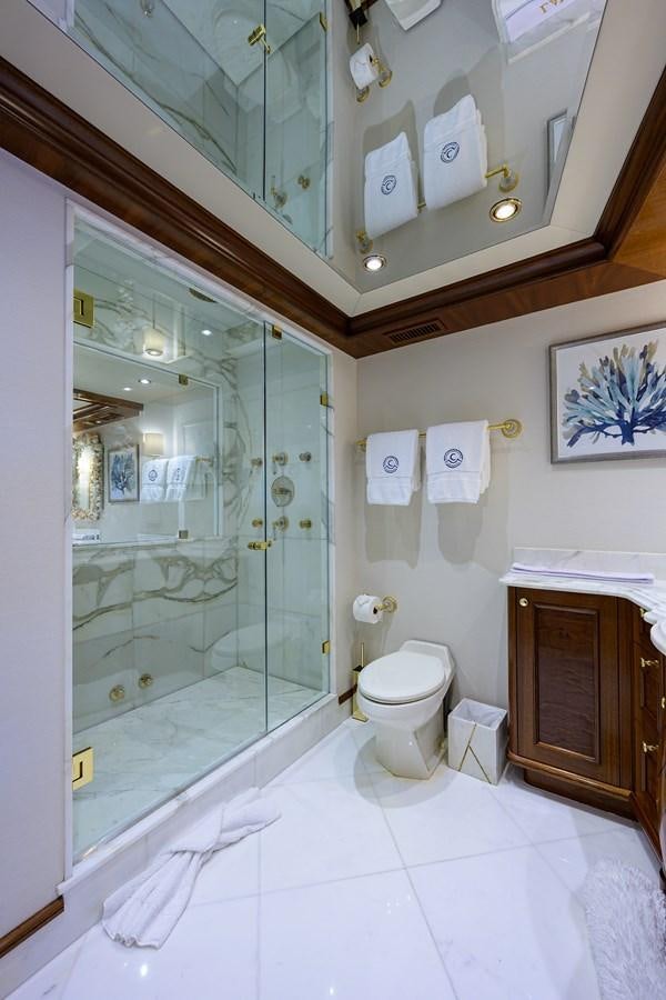 a bathroom with a glass shower aboard REVIVE Yacht for Sale