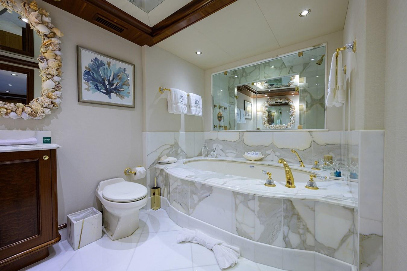 a bathroom with a large mirror aboard REVIVE Yacht for Sale