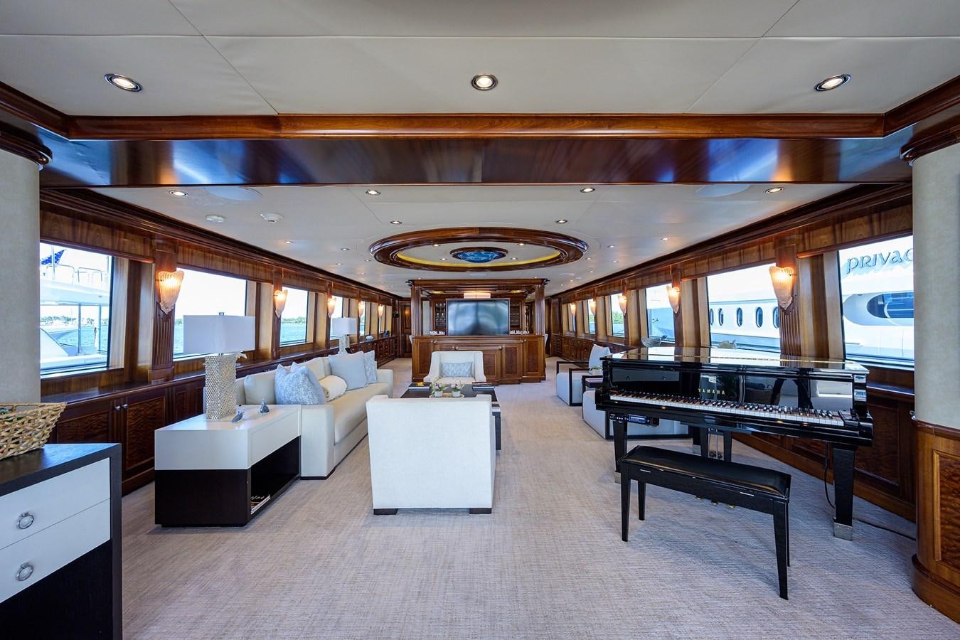 a large living room with a piano aboard REVIVE Yacht for Sale