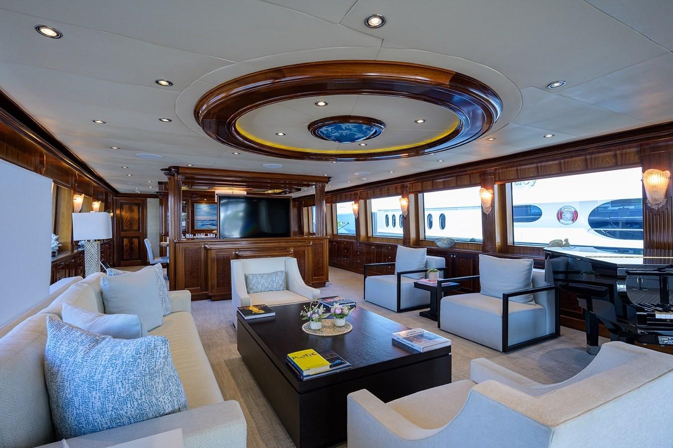 a living room with a large chandelier aboard REVIVE Yacht for Sale