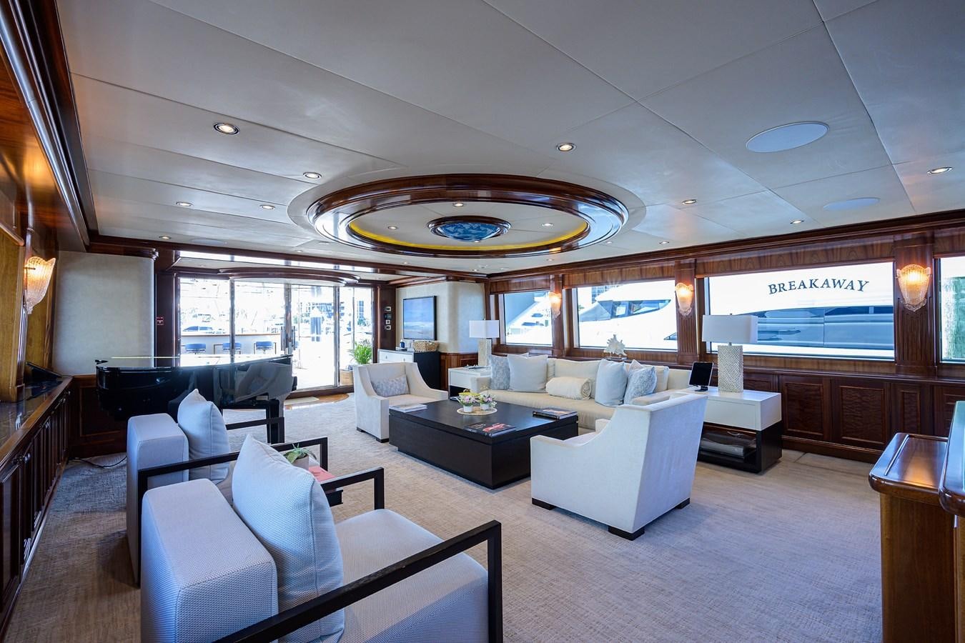 a large living room with a chandelier aboard REVIVE Yacht for Sale