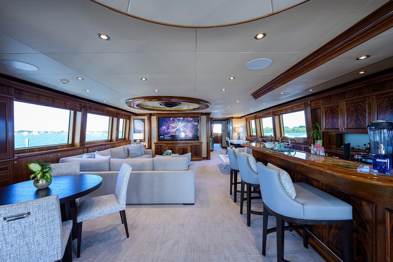 a living room with a table and chairs aboard REVIVE Yacht for Sale