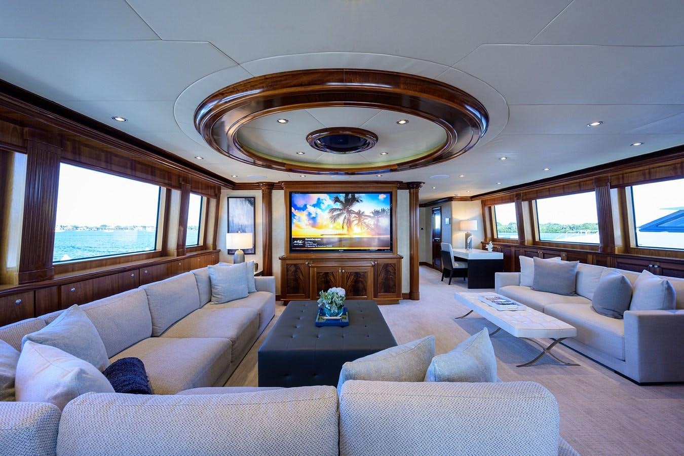 a living room with a large fireplace aboard REVIVE Yacht for Sale