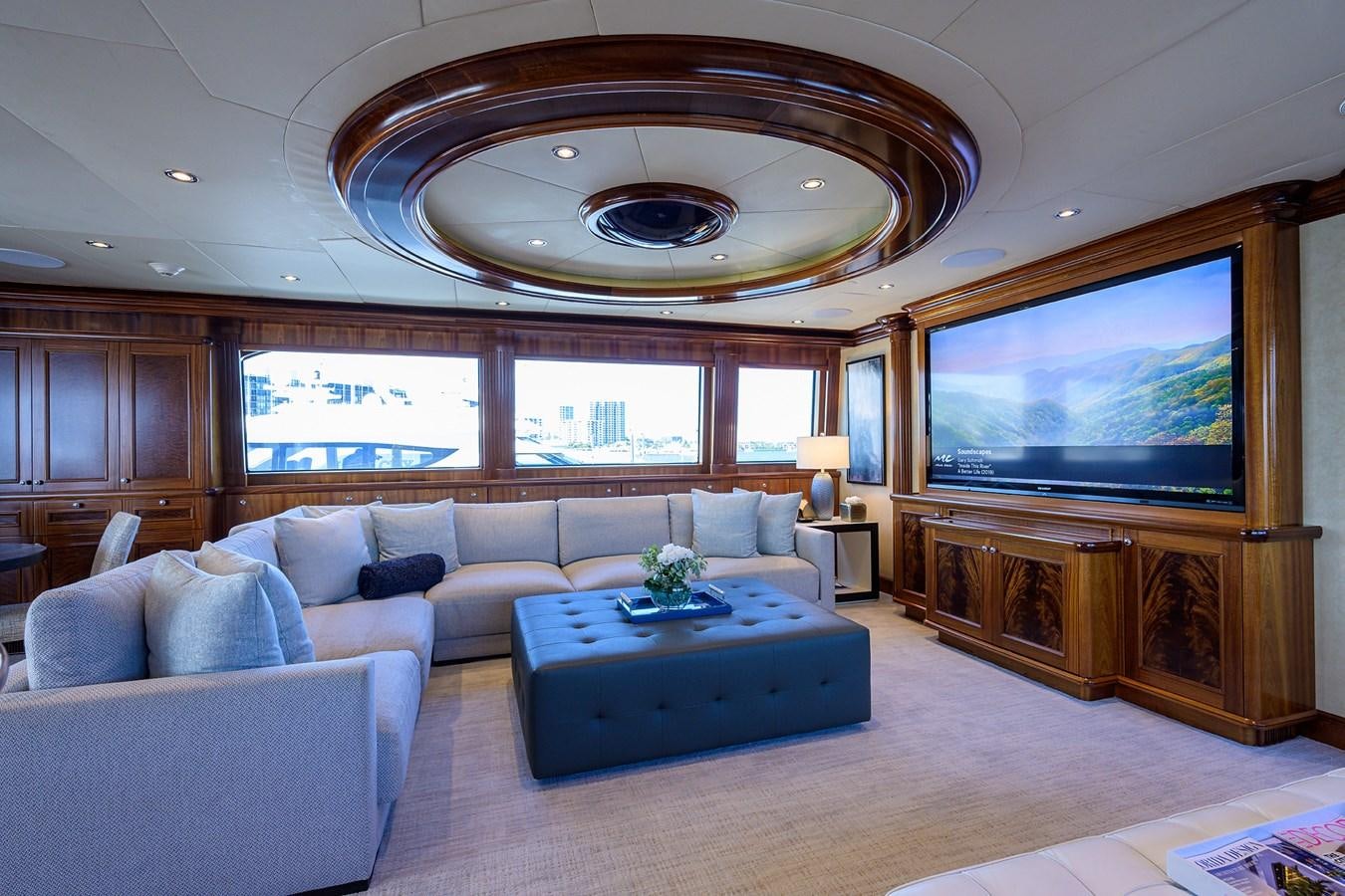 a living room with a large screen aboard REVIVE Yacht for Sale