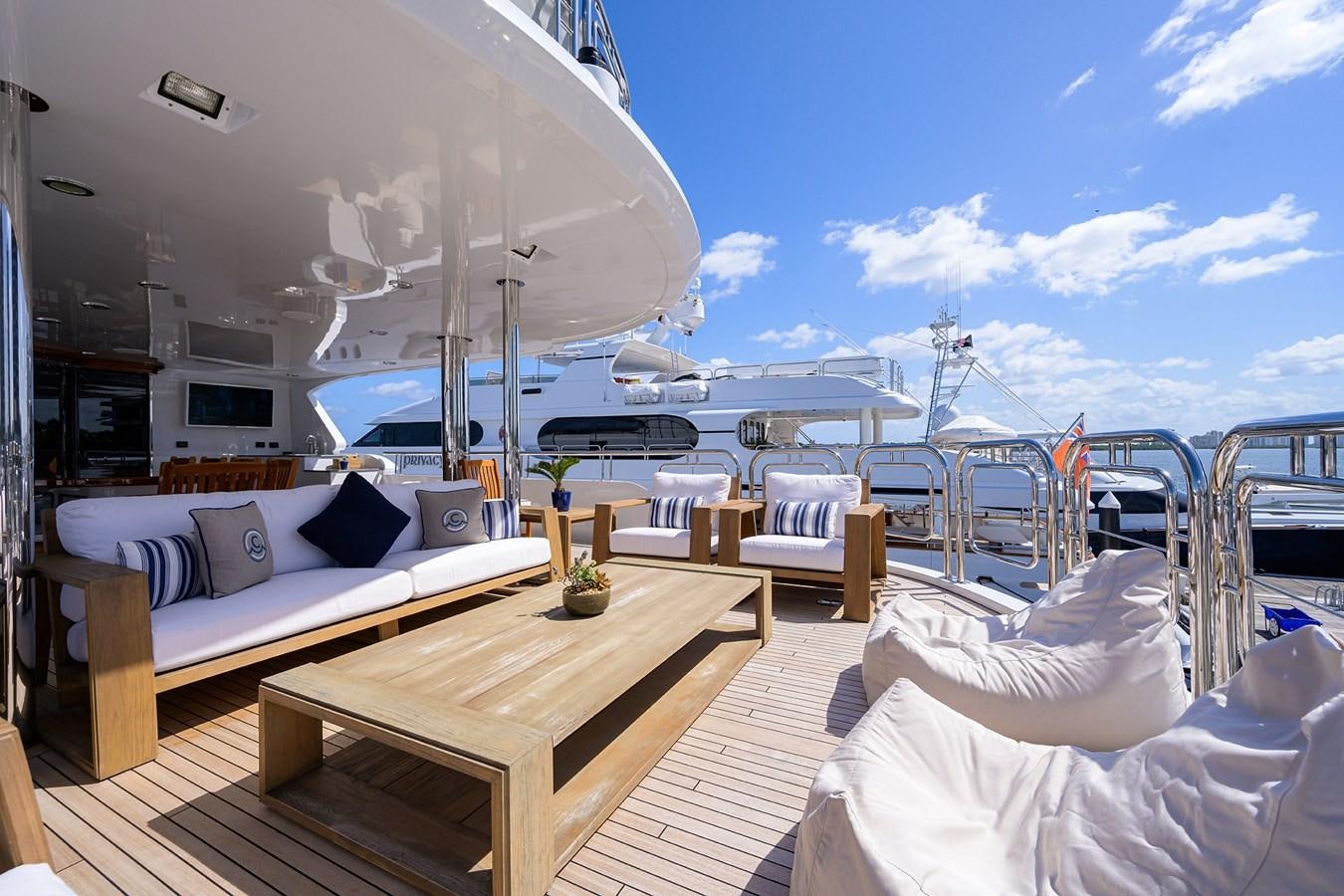 a room with a table and chairs aboard REVIVE Yacht for Sale