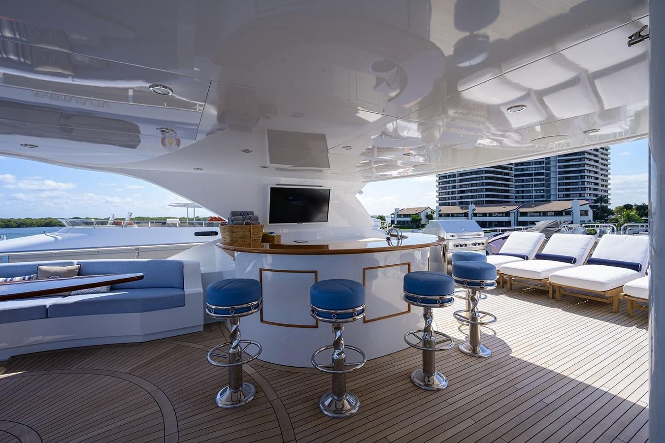 a room with tables and chairs aboard REVIVE Yacht for Sale