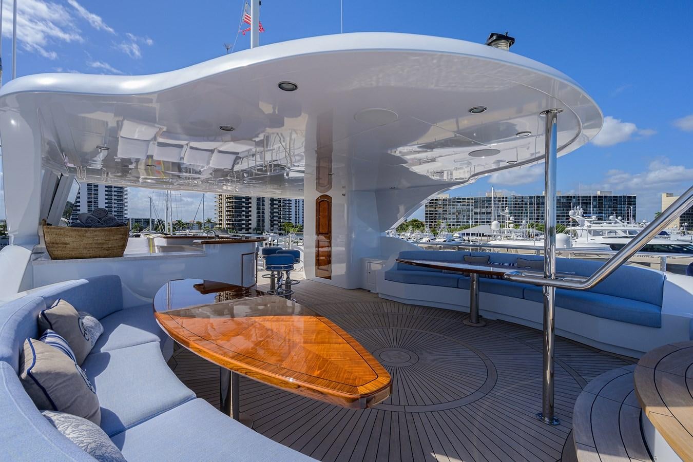 a large ship with a table and chairs on a deck aboard REVIVE Yacht for Sale