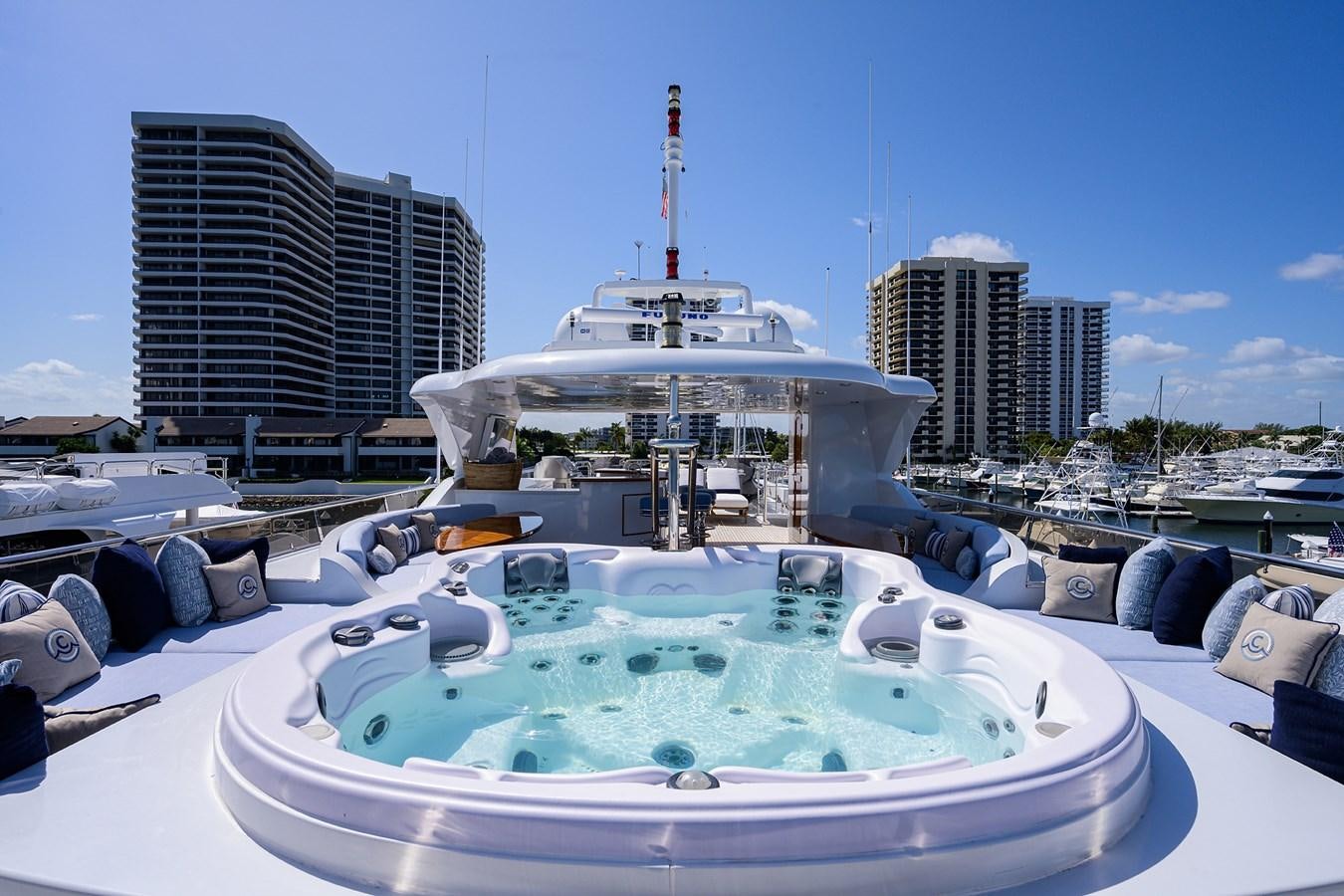 a large white boat in a harbor aboard REVIVE Yacht for Sale